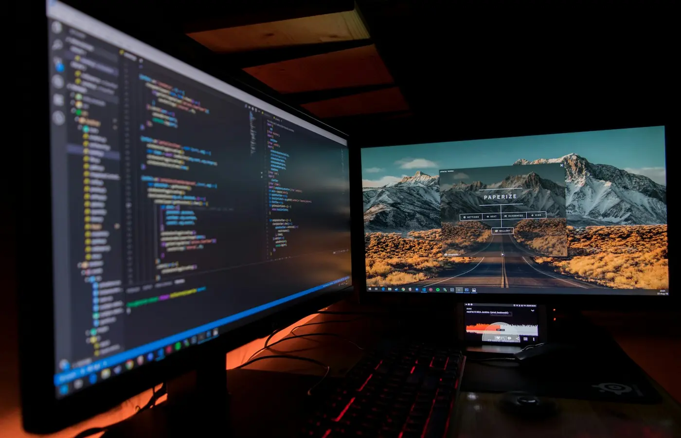 Laptop on a desk with two external monitors